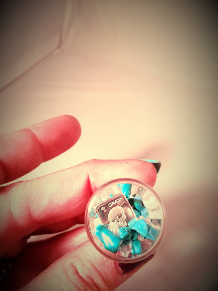 Turquoise skull gram of silver